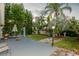 Backyard featuring well-maintained lawn, landscaping, and outdoor patio with seating at 50989 Highway 27 # 176177, Davenport, FL 33897