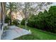 Spacious backyard featuring green grass, large trees, and a concrete patio at 50989 Highway 27 # 176177, Davenport, FL 33897