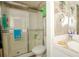 Bathroom featuring shower with glass doors and marble style countertops at 50989 Highway 27 # 176177, Davenport, FL 33897