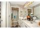 Bright bathroom featuring marble countertops, decorative wallpaper, and modern fixtures at 50989 Highway 27 # 176177, Davenport, FL 33897
