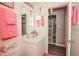 Bathroom with white vanity, framed mirrors and a pink princess-themed decor at 50989 Highway 27 # 176177, Davenport, FL 33897