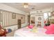 Bedroom featuring a ceiling fan, mirrored closet doors, and patterned wallpaper at 50989 Highway 27 # 176177, Davenport, FL 33897