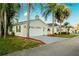 Street view of the attractive home featuring a two-car garage, manicured lawn, and mature landscaping at 50989 Highway 27 # 176177, Davenport, FL 33897