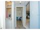 Hallway view including bathroom, wood floors and blue accent wall at 50989 Highway 27 # 176177, Davenport, FL 33897