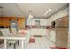 Well-lit kitchen featuring white cabinetry, stainless steel appliances, and an adjacent dining area at 50989 Highway 27 # 176177, Davenport, FL 33897