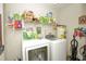 Laundry room with washer, dryer, and ample storage shelves at 50989 Highway 27 # 176177, Davenport, FL 33897