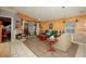 Cozy living space with a mix of tile and wood laminate flooring, leading to a sliding glass door at 50989 Highway 27 # 176177, Davenport, FL 33897