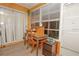 Bright sunroom featuring a ceiling fan, wood style floors, and natural light at 50989 Highway 27 # 176177, Davenport, FL 33897