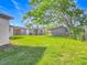 Spacious backyard with green lawn and mature trees, partially fenced for privacy at 514 S Cottage Hill Rd, Orlando, FL 32805