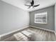 Bedroom featuring wood floors, a ceiling fan, and a window with blinds at 514 S Cottage Hill Rd, Orlando, FL 32805