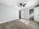Spacious bedroom with ceiling fan, wood-look floors, and ensuite bathroom at 514 S Cottage Hill Rd, Orlando, FL 32805