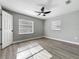 Bedroom with wood floors, ceiling fan, and two windows with blinds at 514 S Cottage Hill Rd, Orlando, FL 32805