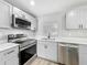 Bright kitchen featuring stainless steel appliances, light gray cabinets, and quartz countertops at 514 S Cottage Hill Rd, Orlando, FL 32805