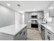 Modern kitchen featuring gray cabinets, stainless steel appliances, and a quartz countertop island at 514 S Cottage Hill Rd, Orlando, FL 32805