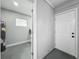 Open laundry room with washer, dryer, hot water tank, and access to backyard at 514 S Cottage Hill Rd, Orlando, FL 32805