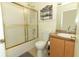 Bathroom featuring a bathtub with sliding glass doors, a toilet, and a vanity with a sink at 519 Beasley Ct, Orlando, FL 32807