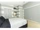 Bedroom with gray and white striped walls, two closets, and a white bedspread at 519 Beasley Ct, Orlando, FL 32807