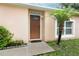 Exterior of home featuring front door with welcome sign, light, palm tree, and walkway at 519 Beasley Ct, Orlando, FL 32807