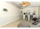 Open living room with tile floors and an archway to the kitchen at 519 Beasley Ct, Orlando, FL 32807