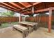 Outdoor patio featuring weathered wood table and bench seating with a pergola at 519 Beasley Ct, Orlando, FL 32807