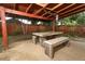 Outdoor patio with weathered wood table and bench seating under a covered pergola at 519 Beasley Ct, Orlando, FL 32807