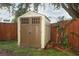 Outdoor shed with double doors and a window, providing extra storage in the backyard at 519 Beasley Ct, Orlando, FL 32807
