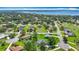 Aerial view of homes in a friendly neighborhood with lush greenery and easy access to the water at 5311 Saddleback Ct, Lady Lake, FL 32159