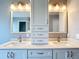 Stylish bathroom featuring double sinks with bright lighting and modern fixtures at 5311 Saddleback Ct, Lady Lake, FL 32159
