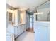 Bright bathroom featuring double sinks, updated fixtures, and a glass shower at 5311 Saddleback Ct, Lady Lake, FL 32159
