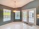 Bright breakfast nook features white tile flooring, a modern light fixture, and views of the pool area at 5311 Saddleback Ct, Lady Lake, FL 32159