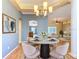 Dining room showcases a stylish chandelier, hardwood floors, and a view into the adjoining living spaces at 5311 Saddleback Ct, Lady Lake, FL 32159