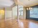Inviting foyer featuring wood floors, a decorative column, and ample natural light filtering through the windows at 5311 Saddleback Ct, Lady Lake, FL 32159