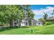 Beautifully landscaped home with solar panels on the roof, offering a blend of charm and modern efficiency at 5311 Saddleback Ct, Lady Lake, FL 32159