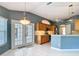 Kitchen with breakfast bar, stainless steel appliances, and views of the backyard through french doors at 5311 Saddleback Ct, Lady Lake, FL 32159