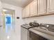 Functional laundry room with modern washer and dryer units and ample storage at 5311 Saddleback Ct, Lady Lake, FL 32159