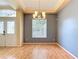 Open-concept living room with wood floors and large window, creating a bright and welcoming space at 5311 Saddleback Ct, Lady Lake, FL 32159