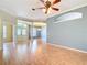Light-filled living room featuring wood floors, high ceilings, and an open floor plan for seamless living and entertaining at 5311 Saddleback Ct, Lady Lake, FL 32159