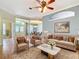 Open-concept living room with hardwood floors, soft natural light, and views into the dining room at 5311 Saddleback Ct, Lady Lake, FL 32159