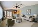 Open-concept living room with vaulted ceilings, ceiling fan, and view into an adjacent kitchen area at 5311 Saddleback Ct, Lady Lake, FL 32159