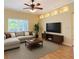Bright living room featuring recessed lighting, ceiling fan, large window, and neutral-toned sectional sofa at 5311 Saddleback Ct, Lady Lake, FL 32159
