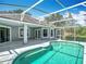 Relaxing screened-in pool area with clear blue water and a spacious patio for entertaining or unwinding at 5311 Saddleback Ct, Lady Lake, FL 32159