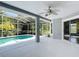 Screened-in lanai with a refreshing swimming pool and lush greenery at 5311 Saddleback Ct, Lady Lake, FL 32159