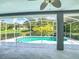 Screened-in lanai with a beautiful swimming pool and serene view at 5311 Saddleback Ct, Lady Lake, FL 32159