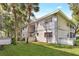 Exterior of the apartment buildings with lush landscaping and palm trees at 563 Midway Trak # K102, Ocala, FL 34472