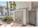 Building exterior with door K102, convenient access, and mature landscaping at 563 Midway Trak # K102, Ocala, FL 34472
