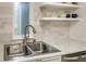 Close-up of the kitchen sink and countertops, showcasing the modern finishes and design at 563 Midway Trak # K102, Ocala, FL 34472