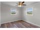 Bedroom featuring neutral colors, ceiling fan and natural light from two windows at 588 Highway 630 E, Frostproof, FL 33843