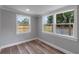This bedroom offers natural light from three windows and is finished with wood-look floors at 588 Highway 630 E, Frostproof, FL 33843