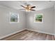 Bedroom featuring neutral colors, ceiling fan and natural light from two windows at 588 Highway 630 E, Frostproof, FL 33843
