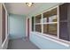 Inviting front porch with a vibrant red door and ample natural light at 588 Highway 630 E, Frostproof, FL 33843